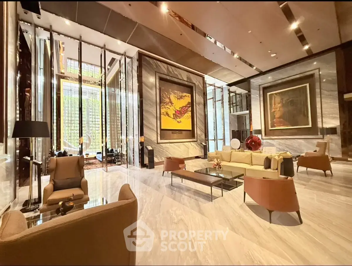 Luxurious modern lobby with elegant seating and stunning artwork in a high-end building.