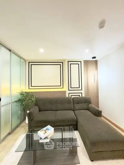 Modern living room with stylish sectional sofa and glass coffee table