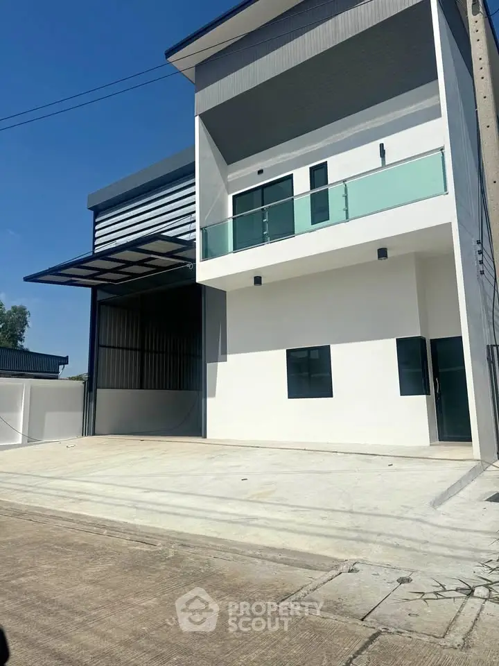 Modern two-story building with sleek design and glass balcony
