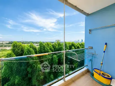 Stunning balcony view with lush greenery and city skyline, perfect for relaxation.