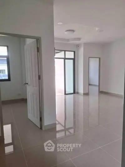 Spacious modern interior with glossy tiled floors and ample natural light, perfect for customization.