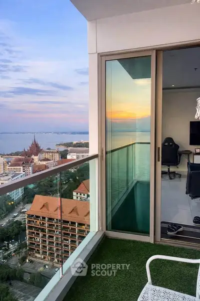 Stunning high-rise balcony with panoramic ocean view and modern interior glimpse.