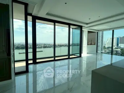Luxurious high-rise apartment with stunning river view and floor-to-ceiling windows.