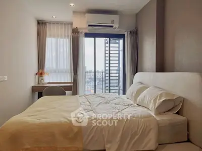 Modern bedroom with city view and cozy decor, perfect for urban living.