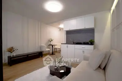 Modern living room with sleek kitchenette and stylish decor