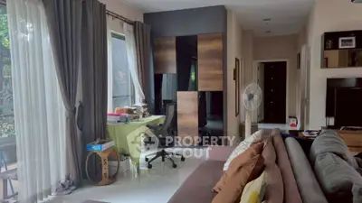 Spacious living room with modern decor and large windows for natural light.