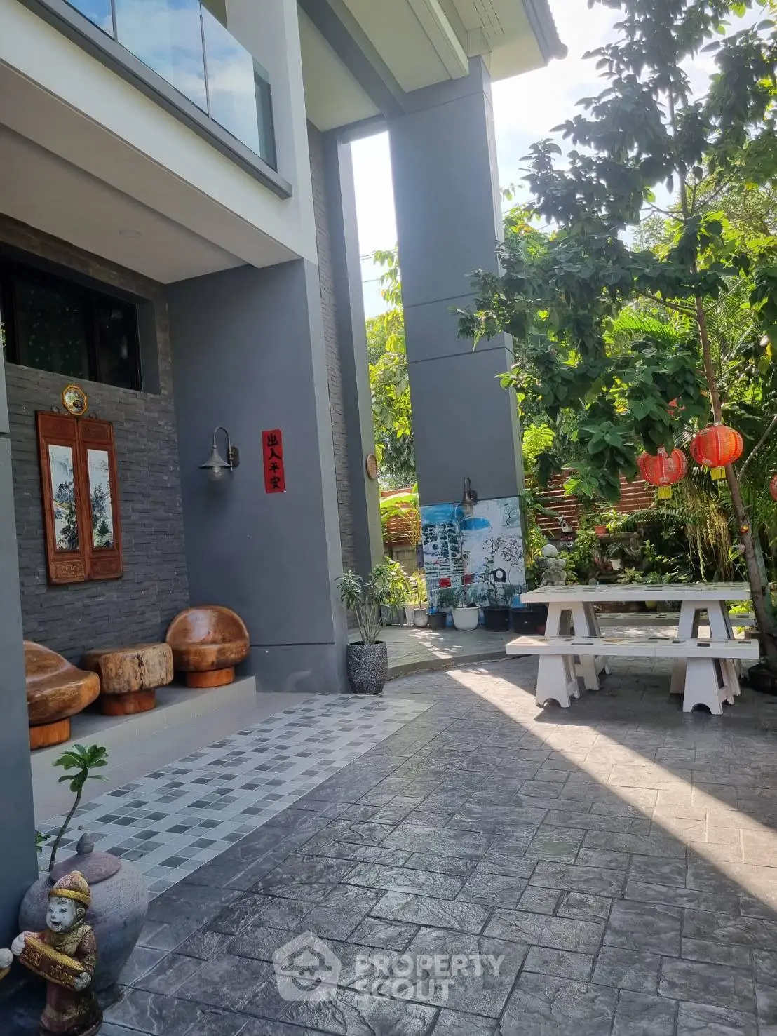 Charming garden patio with modern seating and lush greenery