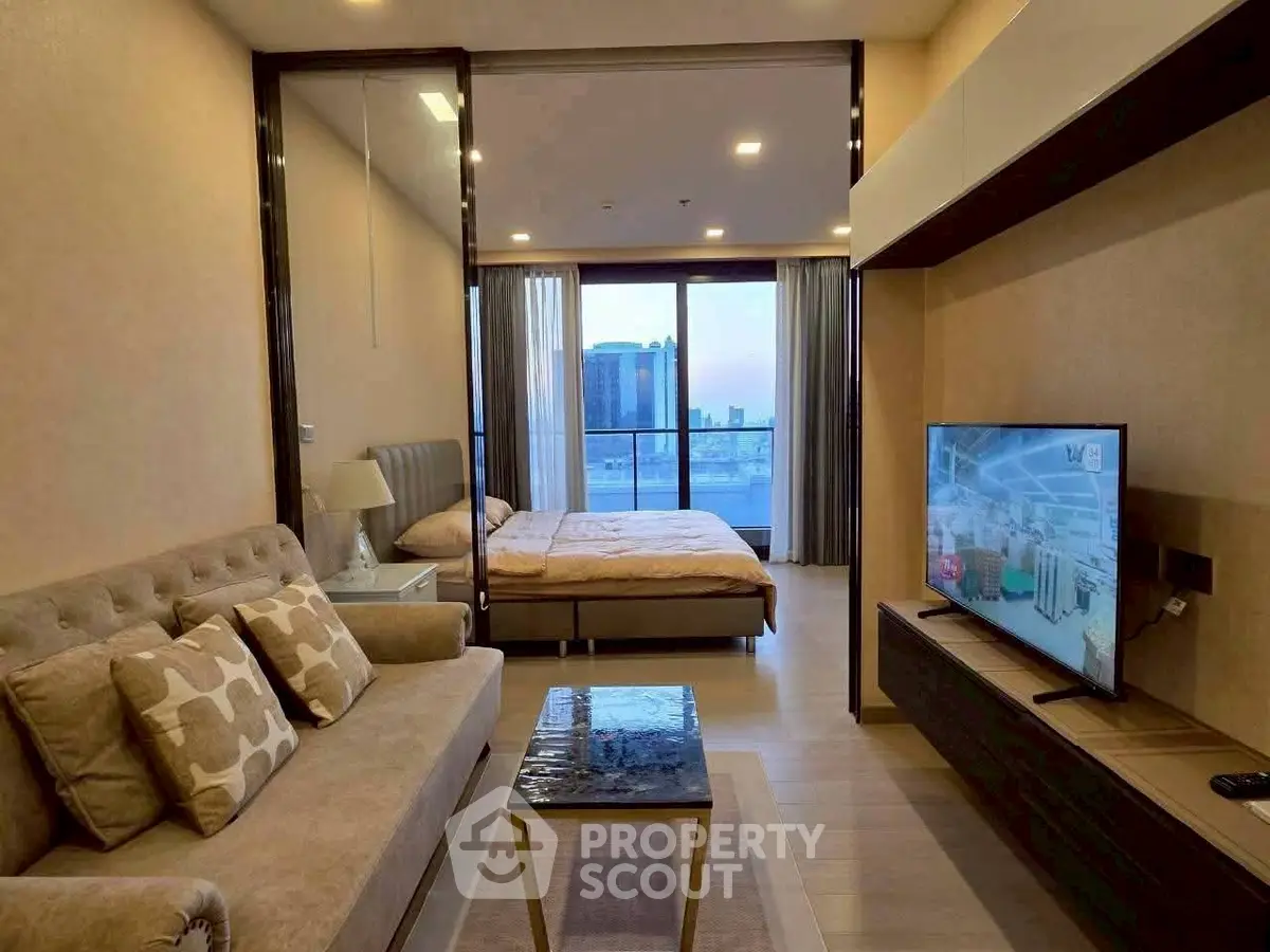 Modern studio apartment with open layout and city view, featuring cozy living area and stylish bedroom.