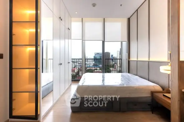 Modern bedroom with floor-to-ceiling windows and city view