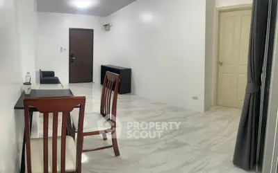 Spacious minimalist living room with modern furniture and elegant marble flooring.