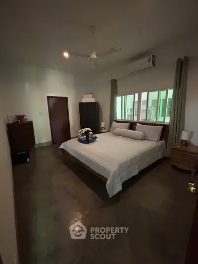 Spacious bedroom with modern decor and natural light