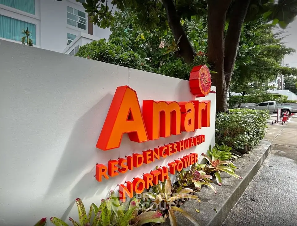 Amari Residences Hua Hin North Tower entrance sign with lush greenery