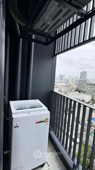 High-rise balcony with washing machine and stunning cityscape view.