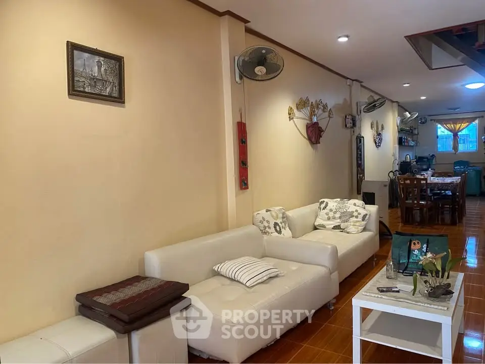 Spacious living room with modern white sofas and elegant decor