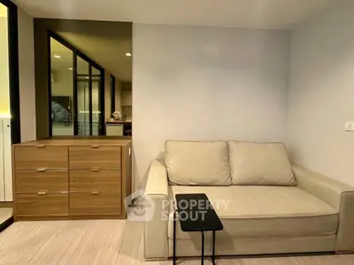 Modern living room with cozy sofa and sleek wooden dresser in stylish apartment