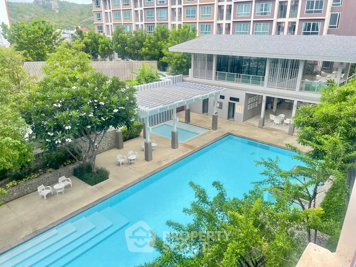 Luxurious condominium with stunning pool and lush greenery, perfect for relaxation and leisure.
