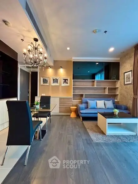 Modern living room with elegant chandelier and stylish furniture