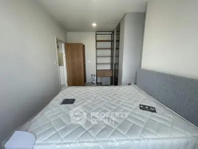 Modern bedroom with minimalist design and large bed in a bright apartment.