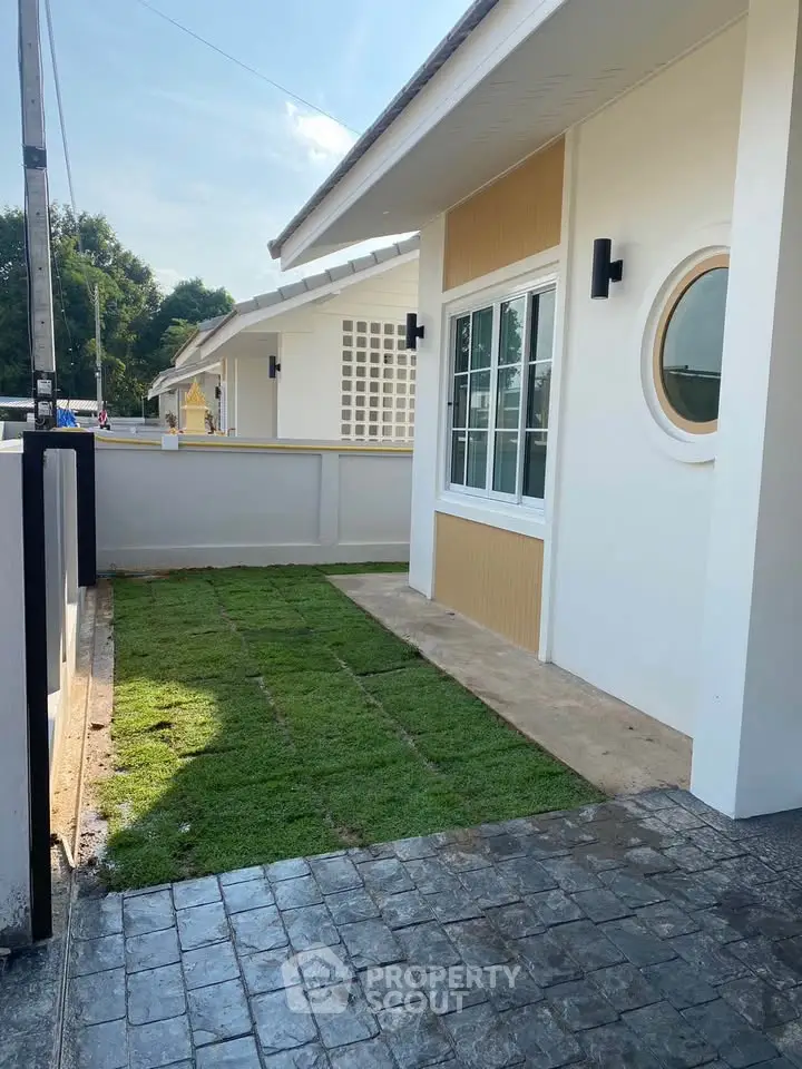 Charming modern house exterior with fresh lawn and stylish windows