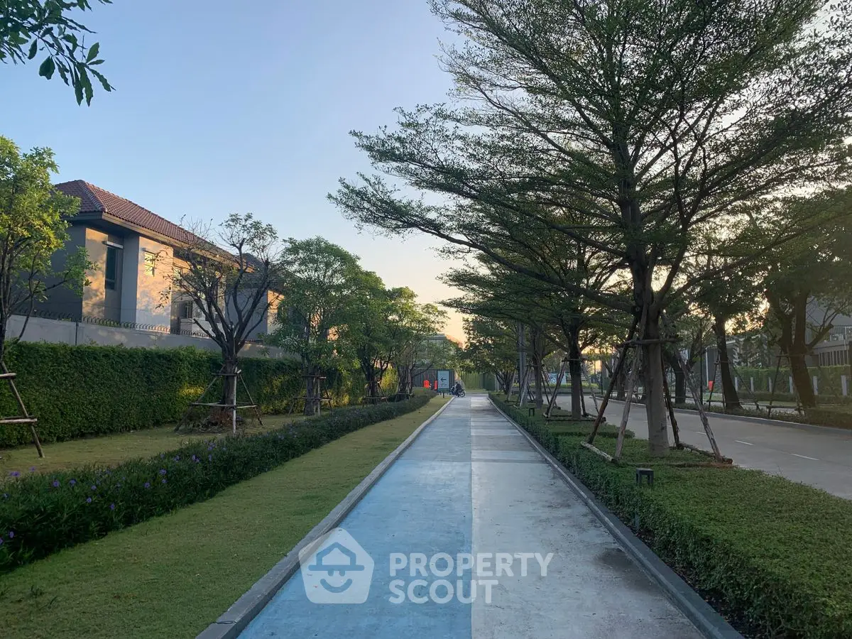 Serene residential walkway with lush greenery and modern architecture