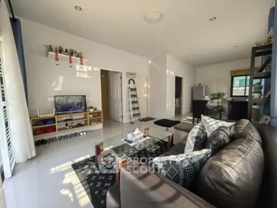 Spacious living room with modern decor and ample natural light