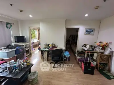 Spacious living room with wooden flooring and ample natural light, ideal for cozy family gatherings.
