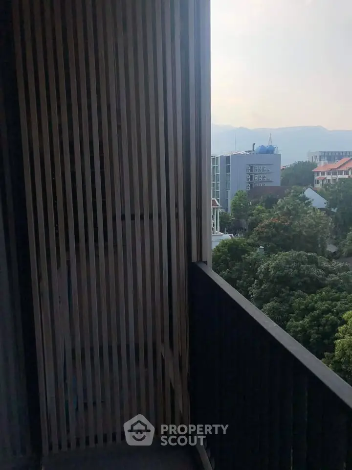 Charming balcony with scenic city view and lush greenery, perfect for relaxation and enjoying the outdoors.