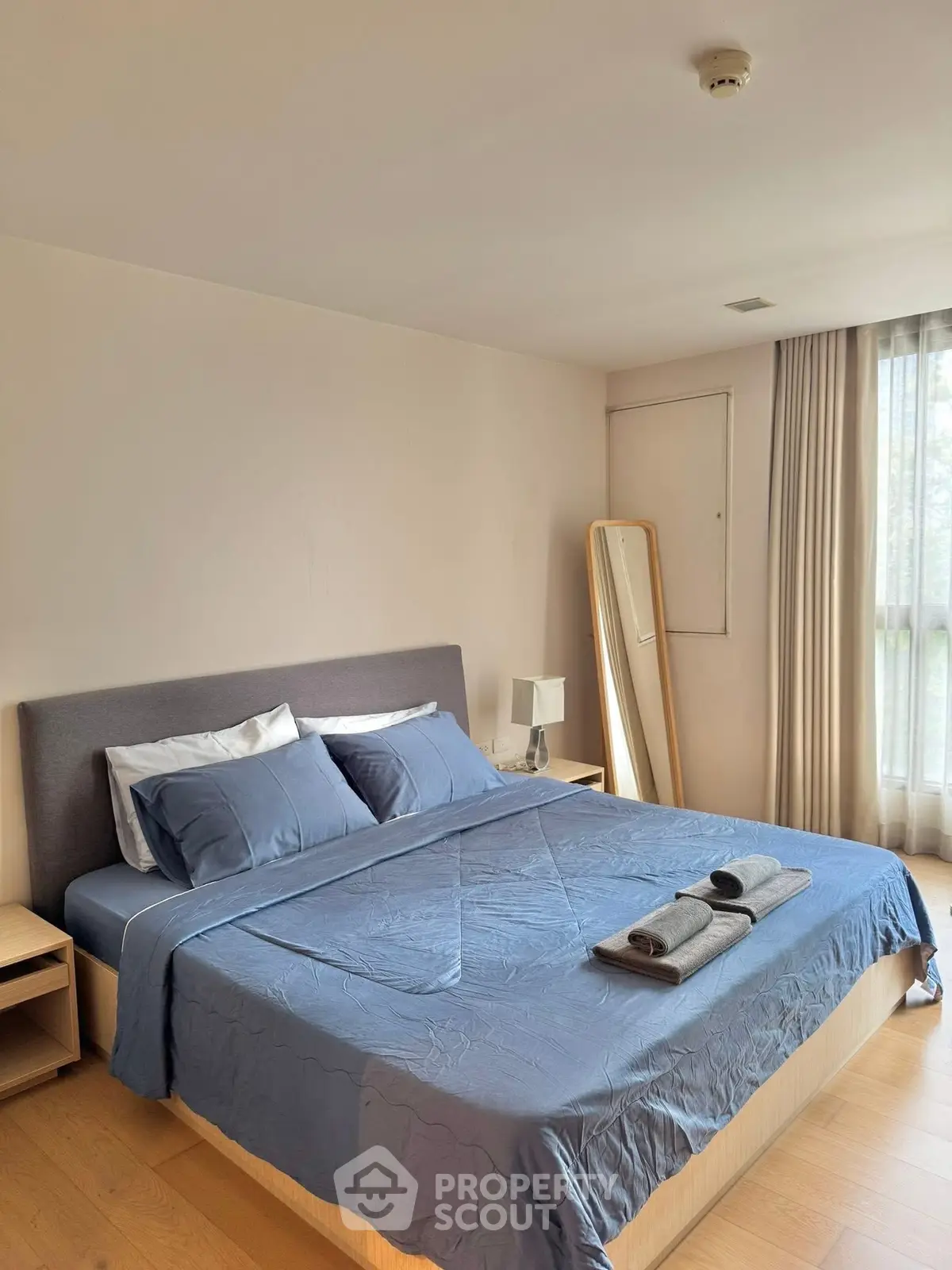 Spacious bedroom with modern decor and natural light