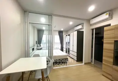 Modern studio apartment with sleek design, featuring a cozy bedroom, dining area, and ample storage space.