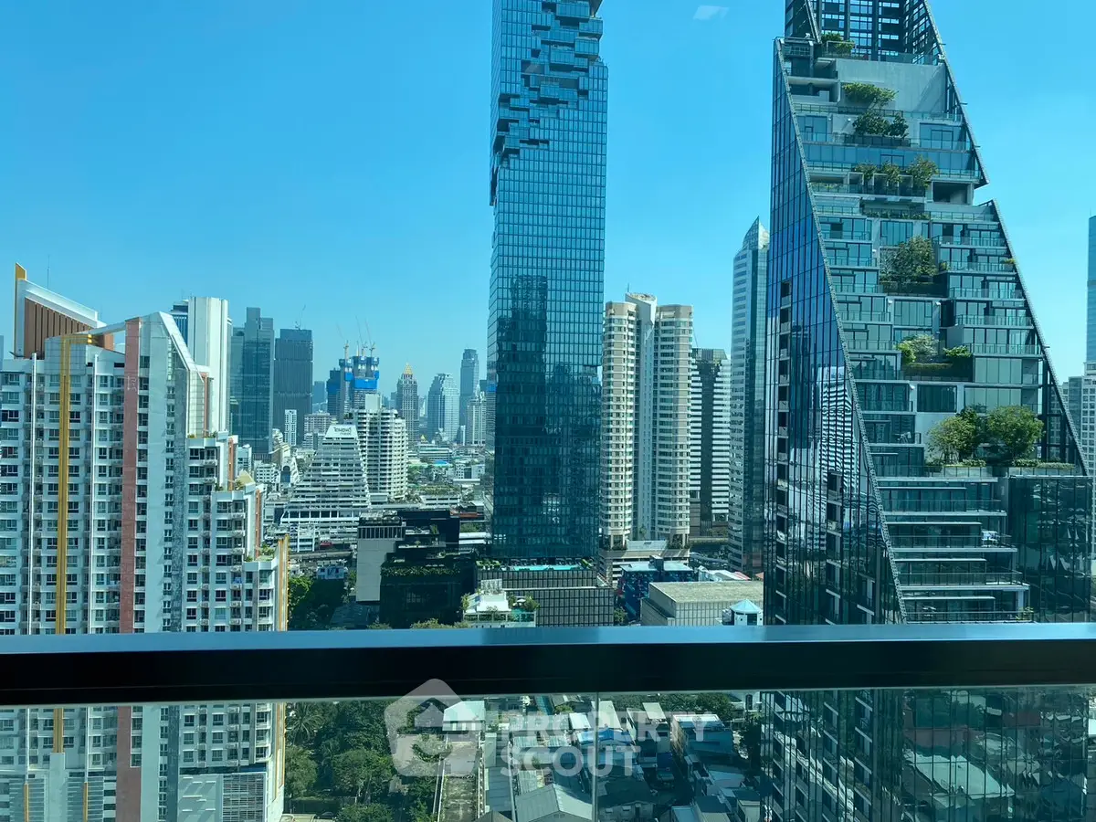 Stunning urban skyline view from a high-rise balcony with modern architecture.
