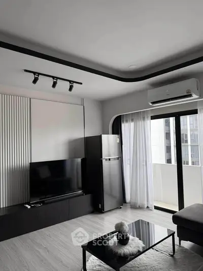 Modern living room with sleek decor, featuring a TV, fridge, and balcony access.