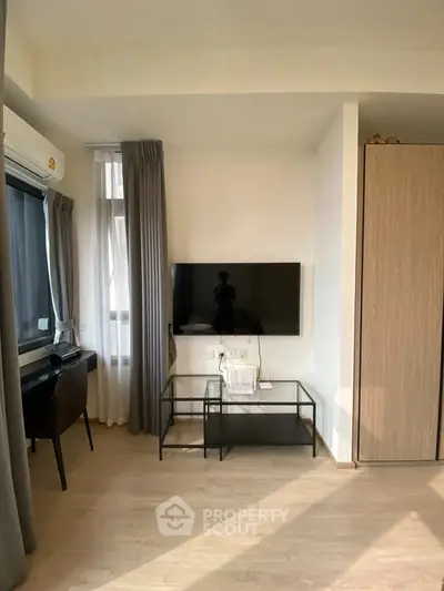 Modern living room with wall-mounted TV and stylish furniture