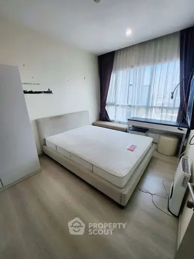 Modern bedroom with large window and minimalist decor