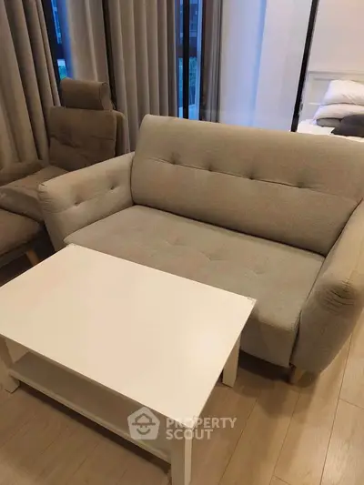 Cozy living room with modern sofa and coffee table, perfect for relaxation.