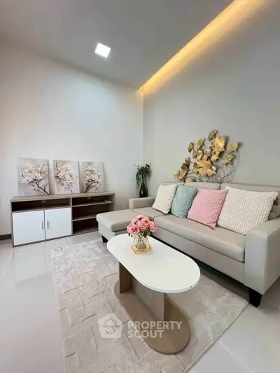 Stylish living room with modern decor, cozy sofa, and elegant wall art in a contemporary home.