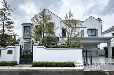 Luxurious modern white villa with elegant facade and lush greenery