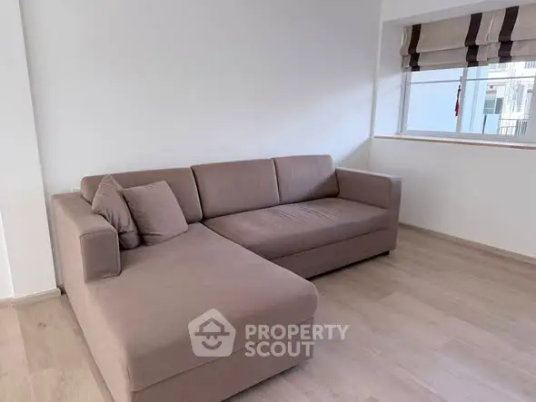 Spacious living room with modern sectional sofa and natural light
