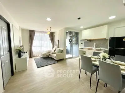 Modern open-plan living room with dining area and kitchen in a bright apartment