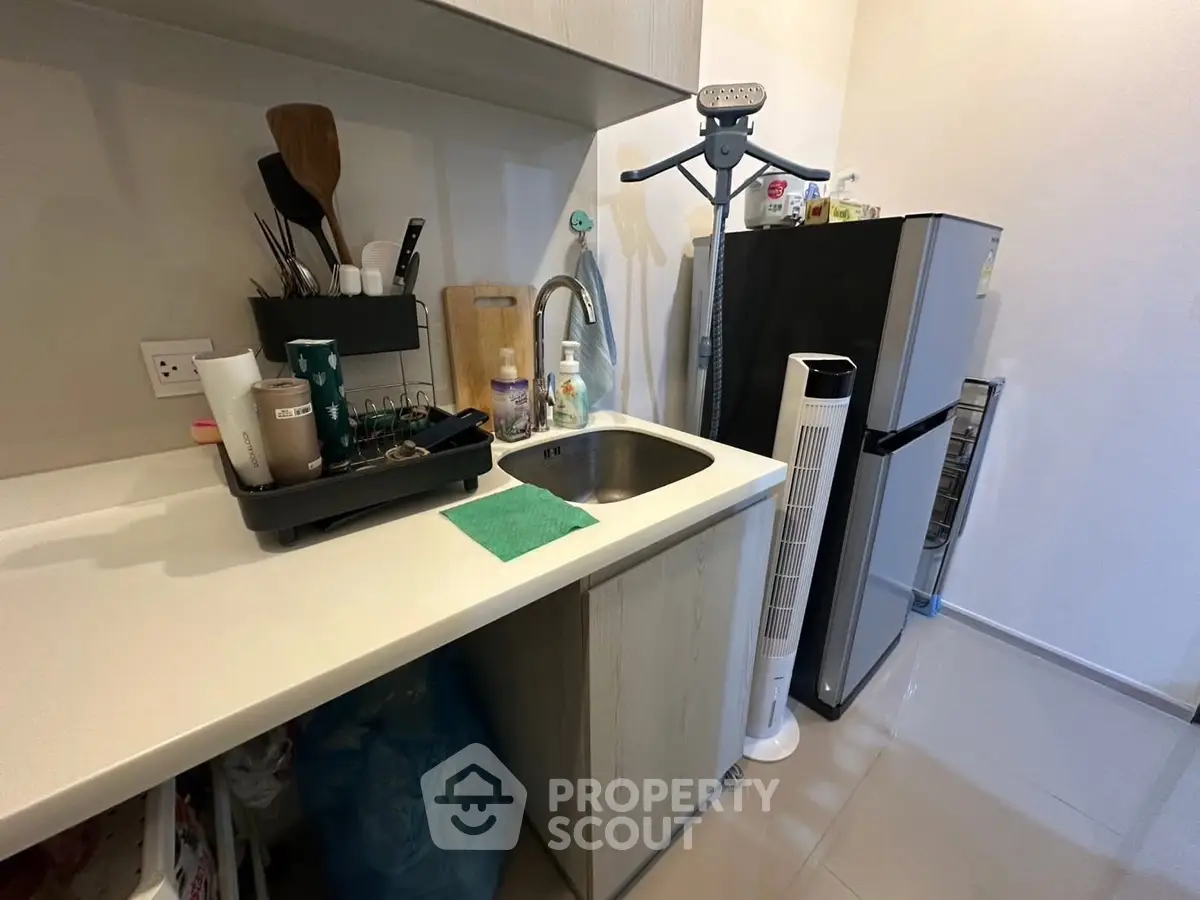 Compact kitchen with modern appliances and sleek countertop