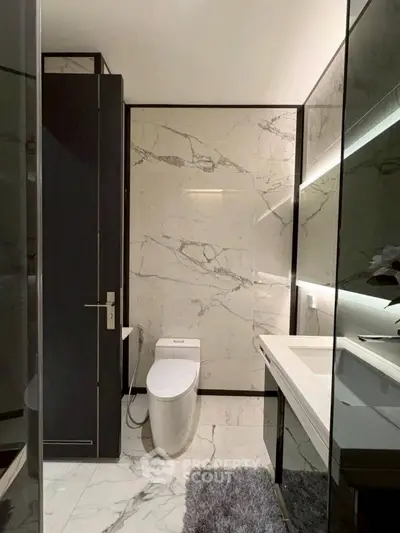 Luxurious marble bathroom with modern fixtures and elegant design.