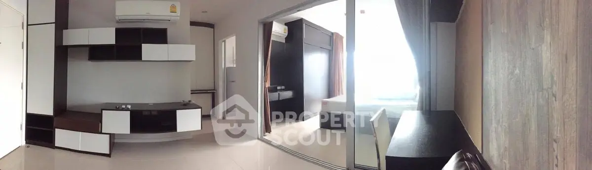 Modern apartment interior with sleek design and ample natural light, featuring a stylish living area and bedroom.