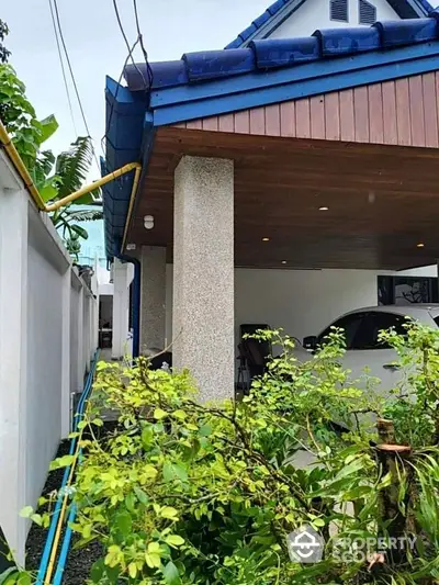 Charming residential carport with lush greenery and modern design elements