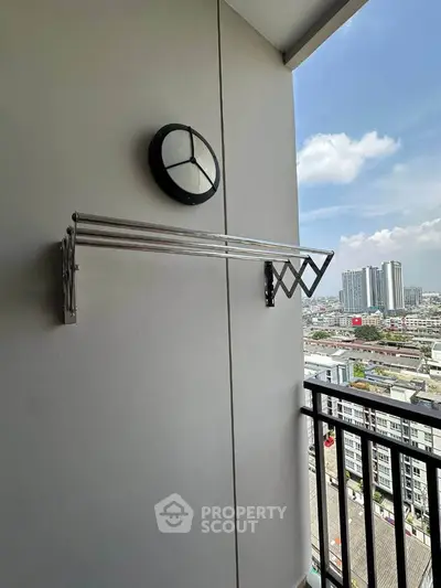 Modern balcony with city view and wall-mounted drying rack