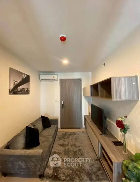 Modern living room with stylish decor and cozy seating in a contemporary apartment.