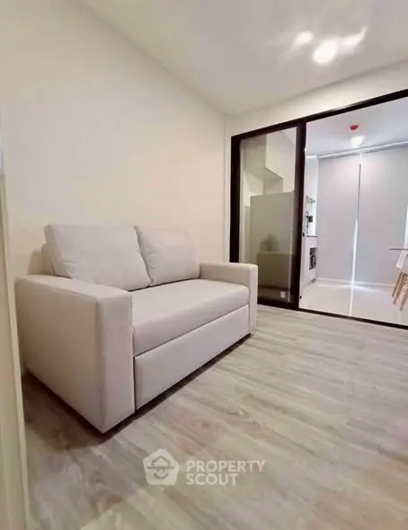 Modern living room with cozy sofa and sleek flooring in a stylish apartment.