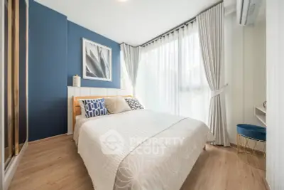 Bright and modern bedroom with stylish decor and large window for natural light.