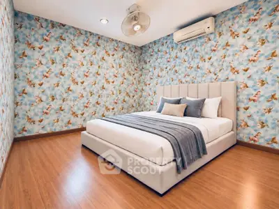 Charming bedroom with unique wallpaper and cozy bed in modern apartment.