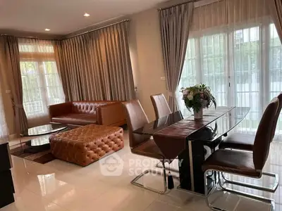 Elegant living room with leather furniture and large windows, perfect for modern living.