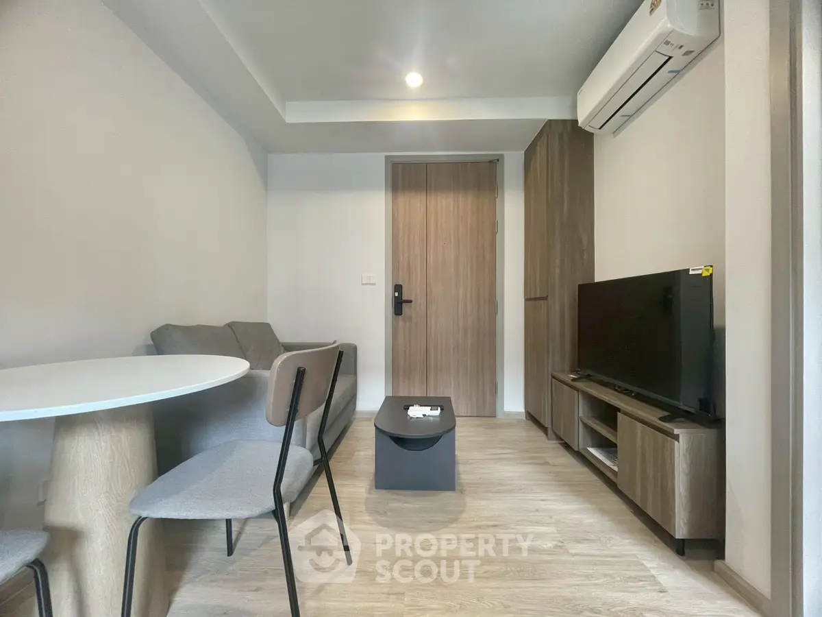 Modern living room with sleek furniture and air conditioning, perfect for cozy urban living.