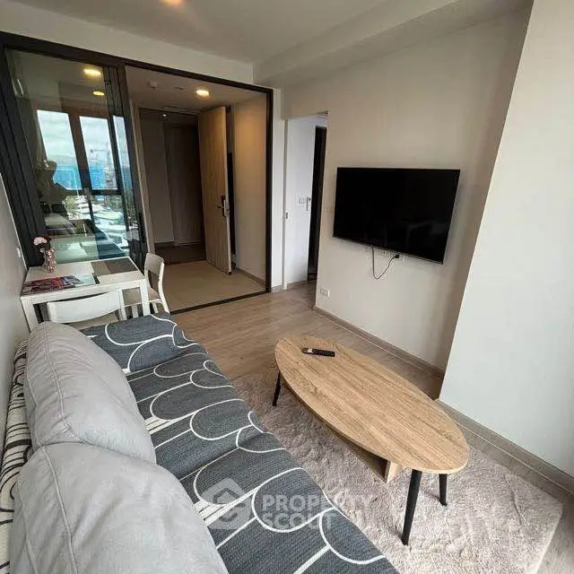 Modern living room with stylish decor and wall-mounted TV in a cozy apartment.